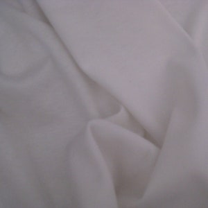 May include: White fabric with a smooth texture and soft folds.