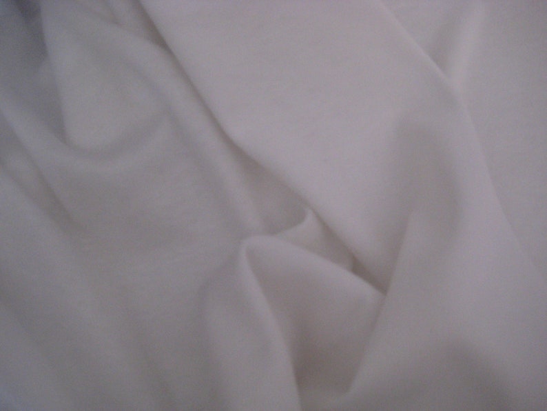 May include: White fabric with a smooth texture and soft folds.
