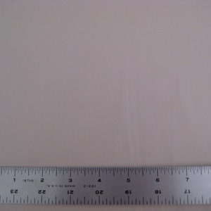 May include: A close-up of a silver ruler with black markings. The ruler is marked in inches and 16ths of an inch. The ruler is labeled "Made in U.S.A."