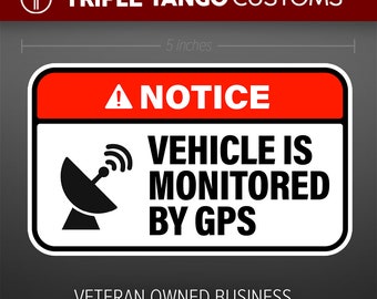 May include: A white and red warning sign with black text and a black satellite dish icon. The sign reads "NOTICE VEHICLE IS MONITORED BY GPS". Below the sign is the text "VETERAN OWNED BUSINESS MADE IN THE USA" with a small American flag.