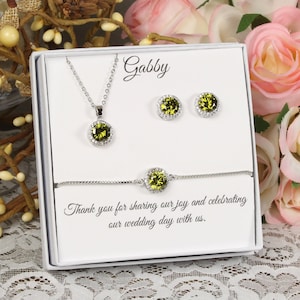 May include: A white gift box containing a green gemstone necklace, earrings, and bracelet. The box is personalised with the message "Gabby Thank you for sharing our joy and celebrating our wedding day with us."