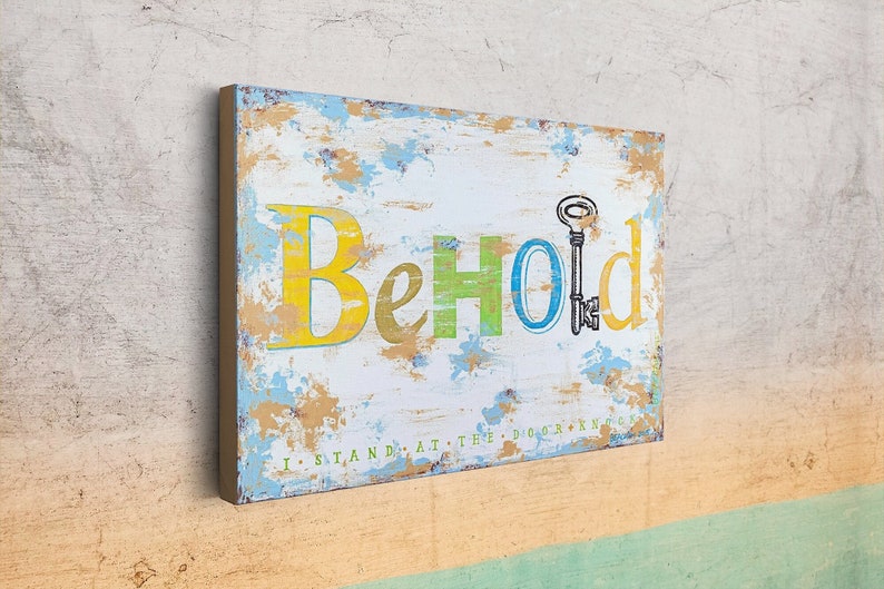 May include: A distressed white wooden sign with the word "Behold" in yellow, green, and blue letters. A small key is drawn above the word. The sign has the text "I stand at the door and knock" in smaller letters at the bottom.