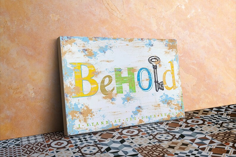 May include: A distressed wooden sign with the word "Behold" in colorful letters. The letters are painted in yellow, green, blue, and yellow. A keyhole is painted in the center of the sign with a key inside.