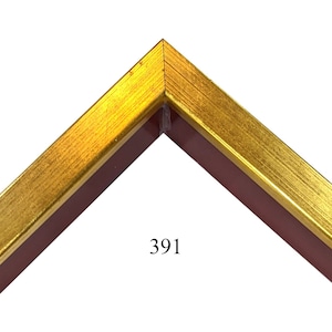 May include: Close-up of a corner of a picture frame with a gold and red finish. The frame has a raised edge and a smooth surface. The number 391 is printed on the frame.