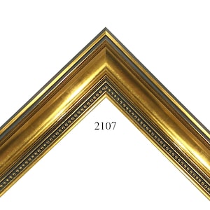 May include: A corner section of a gold-colored picture frame with a dark gray inner edge and a beaded border. The frame has a glossy finish and the number "2107" is visible on the frame.