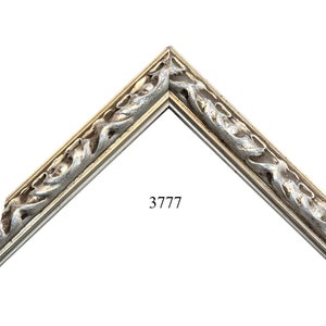 May include: A silver and white ornate picture frame with a decorative, swirling design. The frame is labeled with the number 3777.