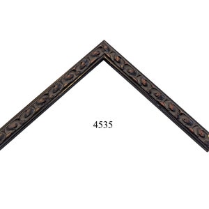 May include: A dark brown wooden picture frame with a decorative, ornate design. The frame has a beveled edge and a smooth finish. The frame is in the shape of a right angle and is labeled with the number 4535.