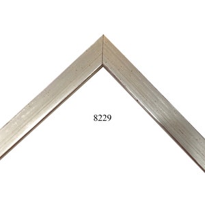 May include: A silver picture frame with a beveled edge and a subtle textured finish. The frame is labeled with the number 8229.