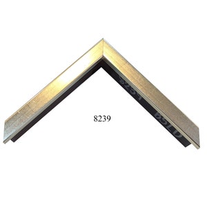May include: A silver picture frame with a black mat. The frame has a beveled edge and a smooth finish. The frame is labeled with the number 8239.