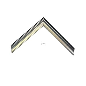 May include: A silver-toned picture frame corner sample featuring a multi-faceted, stepped profile with a metallic finish. The piece is angled to form a V-shape and displays the number 276 printed in black in the center of the open space.