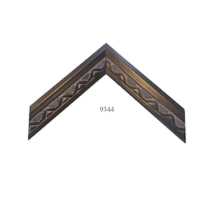 May include: An L-shaped corner section of a picture frame molding with a dark bronze finish. The surface features a repeating geometric pattern of raised zig-zag lines and recessed grooves. The number 9344 is printed in black on the frame.