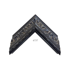 May include: A black picture frame corner sample featuring intricate carved leaf patterns and a beaded edge detail. The frame is marked with the number 6737. The design includes deep relief textures and a dark finish throughout the entire piece.