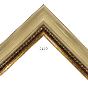 May include: A close-up of a wooden picture frame with a gold rope design. The frame is light brown with a white wash finish. The number 5236 is printed on the frame.