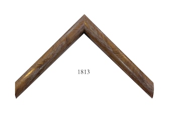 May include: A V-shaped corner section of a picture frame featuring a medium brown wood grain finish with visible textured streaks. The number 1813 is printed in black in the center of the open space between the two angled frame segments.
