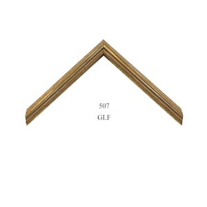 May include: A corner section of a picture frame molding with a metallic gold finish and a series of linear, recessed grooves. The frame features a mitered corner joint and is labeled with the black printed text 507 GLF in the center area.