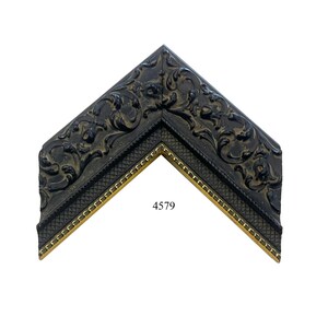 May include: A corner section of a picture frame featuring a dark, ornate finish with raised scrollwork patterns. The inner edge displays a textured cross-hatch design bordered by a thin gold-toned trim. The number 4579 is printed in the center.