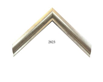 May include: A silver-toned picture frame corner sample featuring a beveled edge and a smooth, metallic finish. The number 2823 is printed in black in the center of the V-shaped frame section, which displays a clean, angled miter joint at the top.