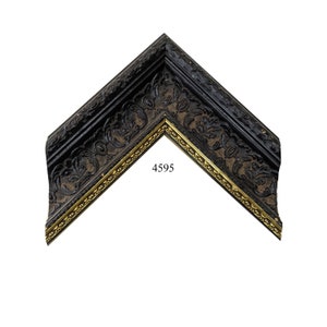 May include: Black picture frame with a gold trim and an ornate design. The frame has the number 4595 printed on it.