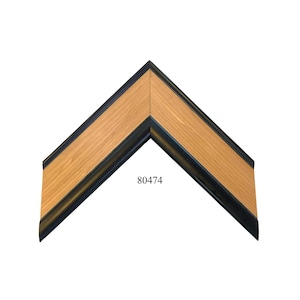 May include: A corner section of a picture frame featuring a light brown wood grain finish on the inner portion and a smooth black border on the outer and inner edges. The number 80474 is printed in black text on the light brown wood surface.