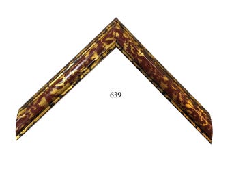 May include: An angled corner section of a picture frame featuring a dark reddish-brown base color with a distressed, mottled gold-tone finish throughout the surface. The number 639 is printed in black in the center of the open space of the frame.