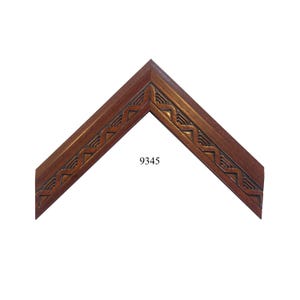 May include: A close-up of a wooden picture frame with a carved design. The frame is a rich brown color and has a simple, elegant design. The frame is labeled with the number 9345.