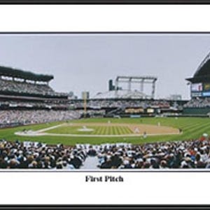 May include: Panoramic framed print of a baseball stadium during a game. The image shows a full stadium with a green field, players, and a crowd of spectators. The text "First Pitch" is at the bottom.