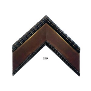 May include: A corner section of a picture frame molding featuring a dark brown, smooth inner panel bordered by glossy black, textured edges with a repeating wave pattern. The number 849 is printed in black text on the inner brown surface.