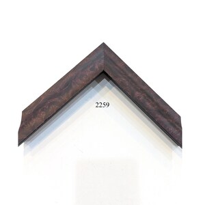 May include: A V-shaped corner section of a picture frame featuring a dark brown wood grain pattern with subtle reddish undertones and a smooth finish. The number 2259 is printed in black text in the center of the V-shaped frame corner piece.