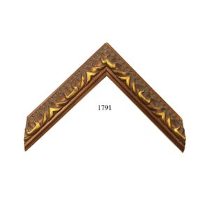 May include: An L-shaped corner section of a picture frame featuring a dark brown finish with gold-toned highlights on the raised decorative carvings. The frame displays a repeating geometric pattern along the inner edge and the number 1791.