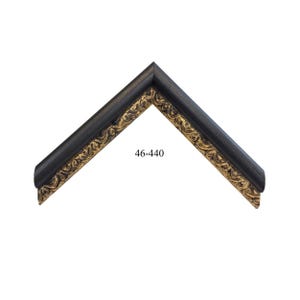 May include: A corner section of a picture frame molding featuring a dark black outer edge and an inner border with a detailed gold-toned ornate relief pattern. The text 46-440 is printed in the center of the frame corner piece.