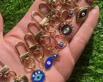 Portachiavi con ciondolo a forma di occhio di Allah, color oro, simbolo protettivo per portafoglio, borsetta, cerniere e chiavi. Un'ottima idea regalo o accessorio.
