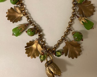 Charm necklace, vtg green art glass beads, brass embossed leaves, brass bead caps, hammered roll chain  brass hook and eye clasp 17.25" long