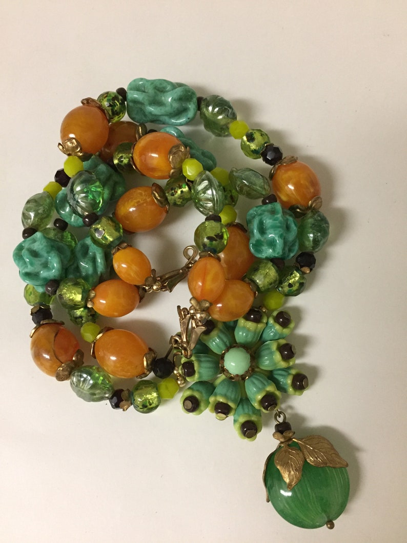 Vintage celluloid flower cluster with glass burgundy seed beads necklace glass beads are green turquoise twists Japanese lamp work