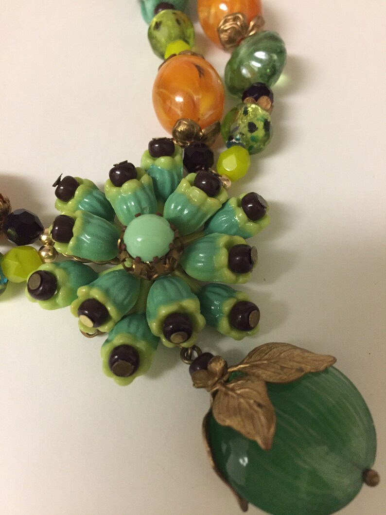 Vintage celluloid flower cluster with glass burgundy seed beads necklace glass beads are green turquoise twists Japanese lamp work