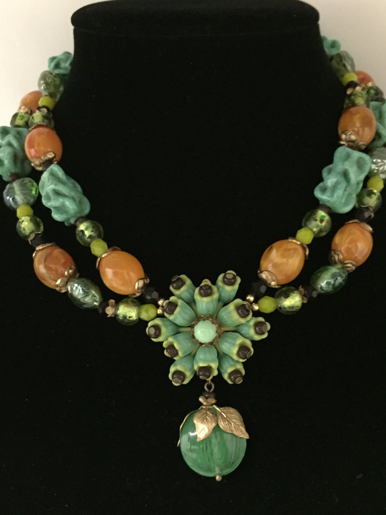 Vintage celluloid flower cluster with glass burgundy seed beads necklace glass beads are green turquoise twists Japanese lamp work