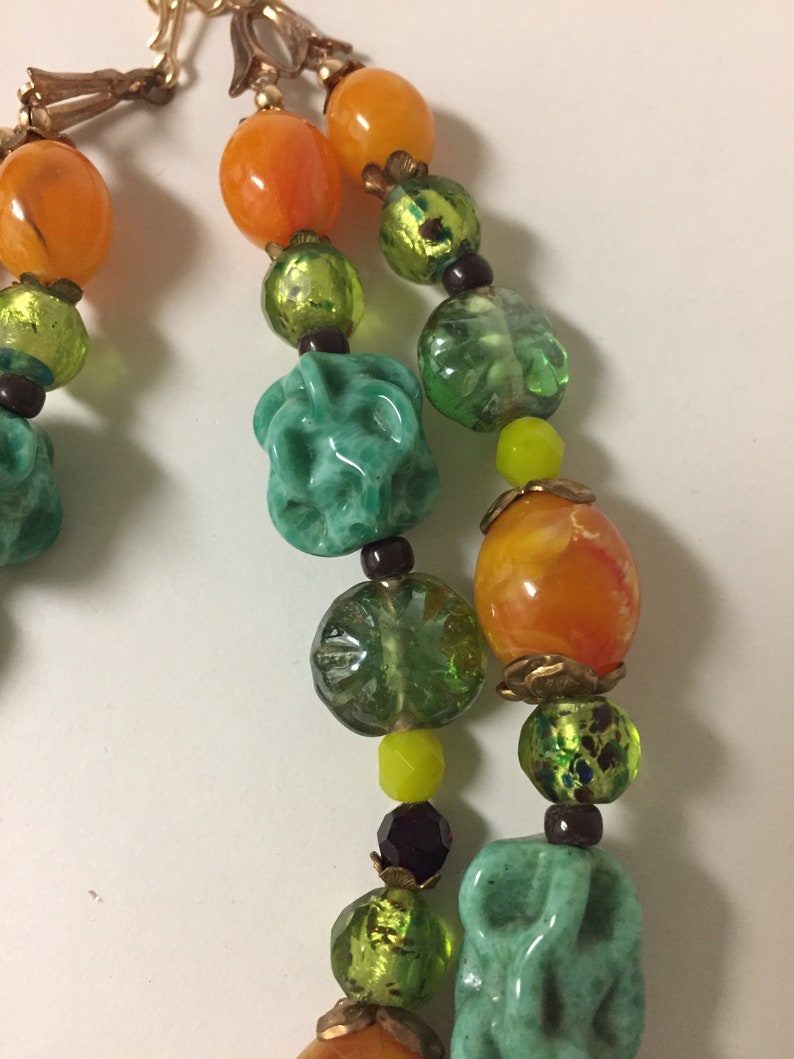 Vintage celluloid flower cluster with glass burgundy seed beads necklace glass beads are green turquoise twists Japanese lamp work