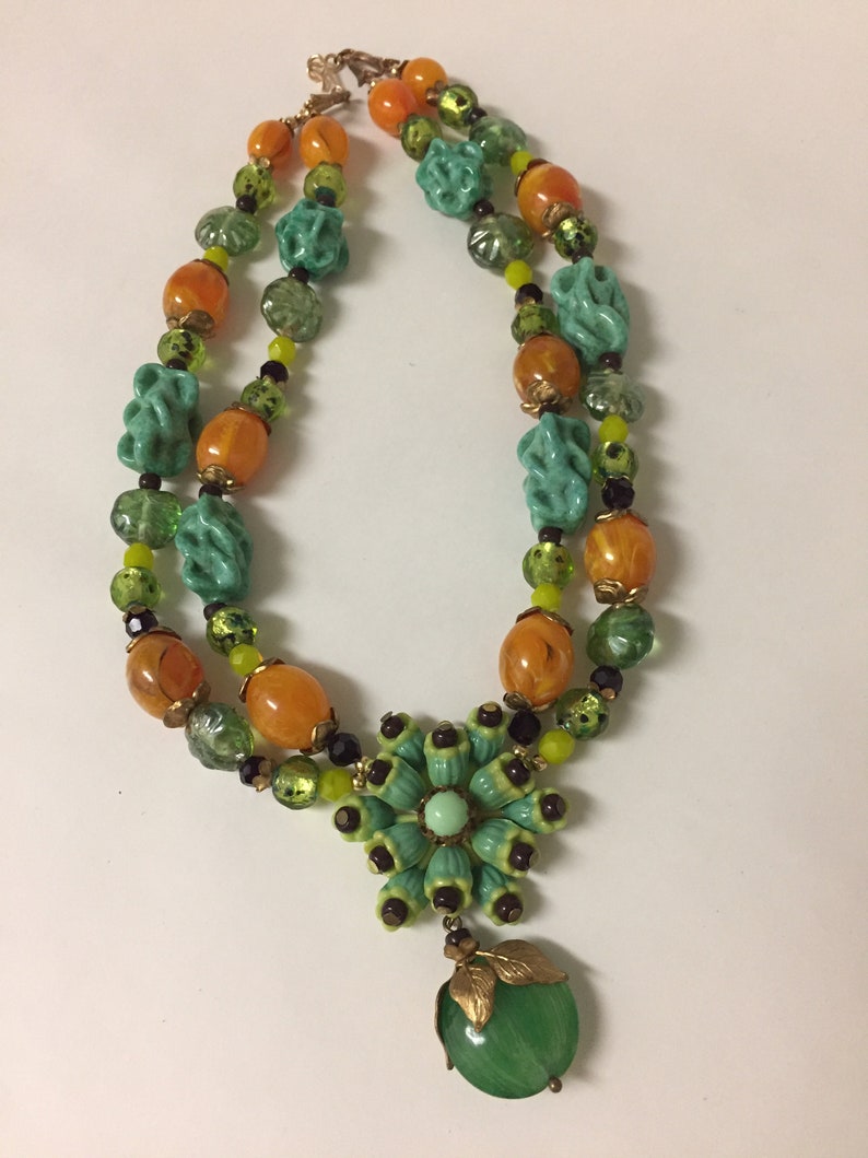 Vintage celluloid flower cluster with glass burgundy seed beads necklace glass beads are green turquoise twists Japanese lamp work