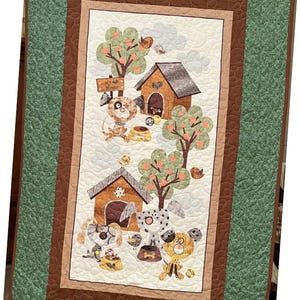 May include: A rectangular quilt featuring a central white panel with illustrations of dogs, doghouses, trees, and food bowls. The text "My Home" is visible on a wooden sign. The quilt has a brown inner border and a wide, textured green outer border.