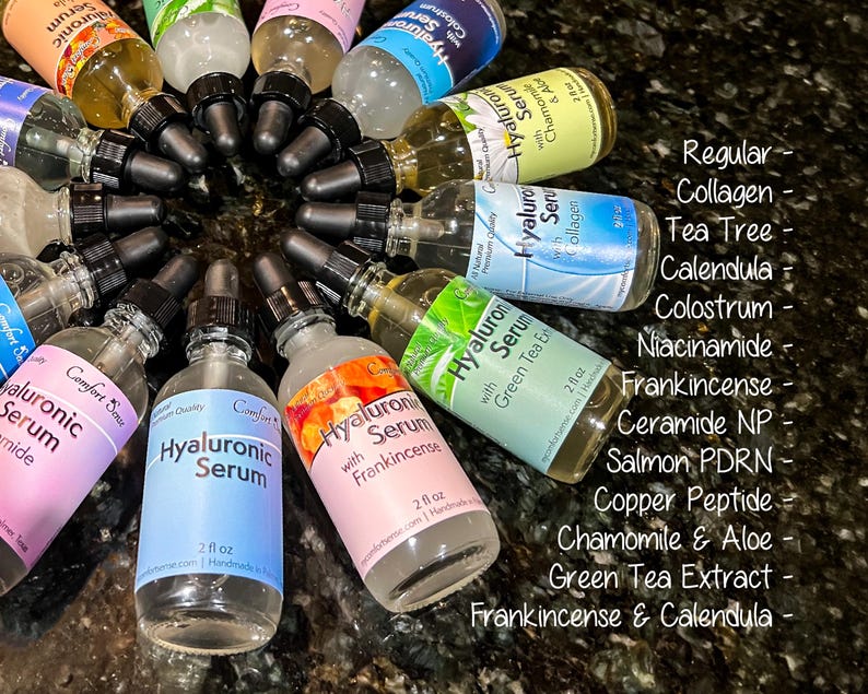 May include: A collection of clear glass dropper bottles containing Hyaluronic Serum with various labels including Collagen, Tea Tree, Calendula, Colostrum, Niacinamide, Frankincense, Ceramide NP, Salmon PDRN, Chamomile & Aloe, and Green Tea Extract.