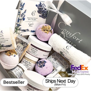May include: A gray gift box filled with lavender-scented bath products, including bath bombs, bath salts, body butter, soap, and a loofah. The box is labeled "Comfort Sense" and includes the text "Bestseller" and "Ships Next Day (Mon-Fri)".