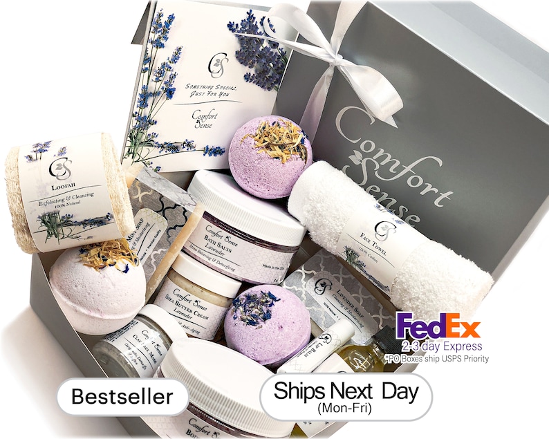 May include: A gray gift box filled with lavender-scented bath products, including bath bombs, bath salts, body butter, soap, and a loofah. The box is labeled "Comfort Sense" and includes the text "Bestseller" and "Ships Next Day (Mon-Fri)".