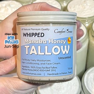 May include: A white ceramic mug with a black handle and the text "But First, Coffee" in a black, handwritten-style font. The mug is on a white surface.