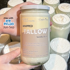 May include: A jar of whipped tallow with a white lid, held by a person wearing gloves. The label reads "WHIPPED TALLOW Vanilla Bean" and "Full Body Daily Moisturizer, Hair Conditioning, and Face Cream." Other jars are in the background.