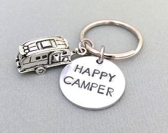 May include: Silver keychain with a small camper charm and a round tag that says "Happy Camper".