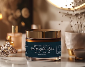 May include: A gold jar with a dark blue label that reads "Blossom Beauty Co. Midnight Glow Body Balm Net Weight 8.5 oz."