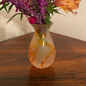 Cute little frosted vase with orange floral motifs