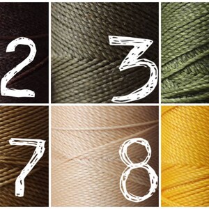 May include: Ten spools of thread in various colors, numbered 1 through 10. The colors are black, brown, green, yellow, and pink.