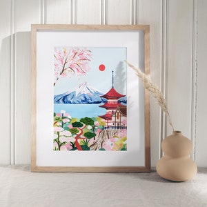 May include: A framed print of a Japanese landscape with a red pagoda, a mountain, and cherry blossoms. The print is in a light wood frame.