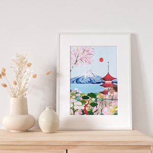May include: A framed illustration of Mount Fuji with a red pagoda in the foreground. The mountain is surrounded by a blue lake and a lush green forest with pink cherry blossoms. A red sun is visible in the sky.