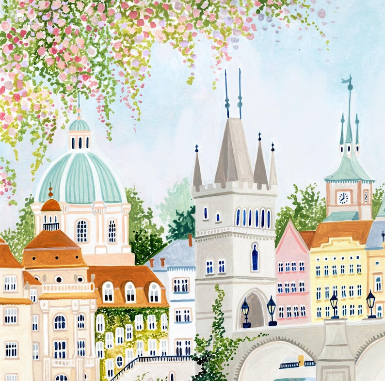 May include: A watercolor painting of a European city with a bridge, buildings, and a clock tower. The buildings are painted in shades of pink, yellow, and white. The sky is a light blue with white clouds. There are trees and flowers in the foreground.